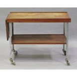 A mid-20th century teak and painted steel two-tier trolley with drop-flap extending end, height