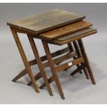 A mid-20th century walnut nest of three occasional tables, on angular legs, height 51cm, width 57cm,