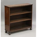 A Regency mahogany open bookcase, the reeded top above two shelves, on reeded bun feet, height 82cm,