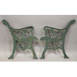 A pair of early 20th century green painted cast iron garden bench ends of scrolling form, height