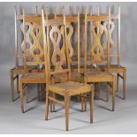 A set of eight Arts and Crafts oak framed chairs, after a design by Charles Francis Annesley Voysey,