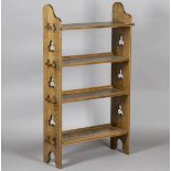An Edwardian Arts and Crafts oak four-tier 'Sedley' bookcase by Liberty & Co, the pegged sides