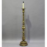 An early 20th century Continental carved giltwood lamp standard, worked with acanthus leaf knops,