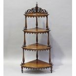 A Victorian figured mahogany graduated four-tier bowfront whatnot with fretwork frieze and aprons,