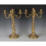 A pair of late 20th century cast gilt metal five-light candelabra with figural stems and circular