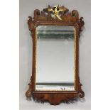 A George III mahogany fretwork framed wall mirror, the pierced top carved and gilded with a phoenix,