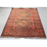A Pakistan rug, late 20th century, the deep claret field with two eagle medallions, within a