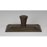 A 19th century brown patinated cast bronze inkstand, the central stop fluted inkwell with hinged