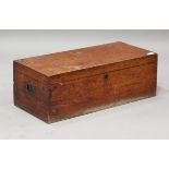 A late Victorian teak trunk with brass recessed handles, the baize-lined interior fitted with a