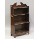 A 20th century reproduction mahogany open waterfall bookcase, the sides with applied brass