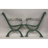 A pair of 20th century green painted cast iron garden bench ends of 'X' frame form, height 81cm,