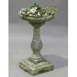 A 20th century cast composition stone bird bath, the reeded circular bowl planted with a mix of
