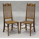 A pair of Edwardian Arts and Crafts oak framed side chairs, probably Scottish, the arched top