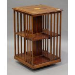 A late 20th century reproduction yew revolving bookcase with inlaid fan patera, height 80cm, width
