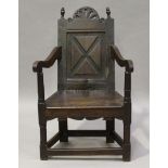 A 19th century oak Wainscot armchair, the panelled back above a solid panel seat, height 98cm, width