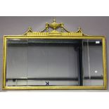 A 20th century Neoclassical giltwood wall mirror with a sectional plate glass and flaming urn