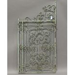 A 19th century green painted wrought iron single gate of scrollwork form, height 170cm, width 87cm.