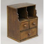 An 18th century oak table-top spice chest, fitted with two open shelves above three drawers,