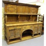 A large late Victorian Aesthetic Movement oak sideboard, the panelled shelf back above three drawers