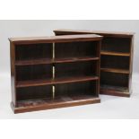 A pair of modern reproduction mahogany open bookcases with crossbanded tops and adjustable