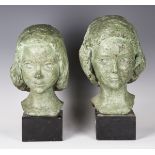 Two 20th century green patinated cast bronze busts of young girls, both mounted on ebonized bases,