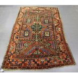 A Kazak rug, West Caucasus, early 20th century, the claret field with a central angular medallion,