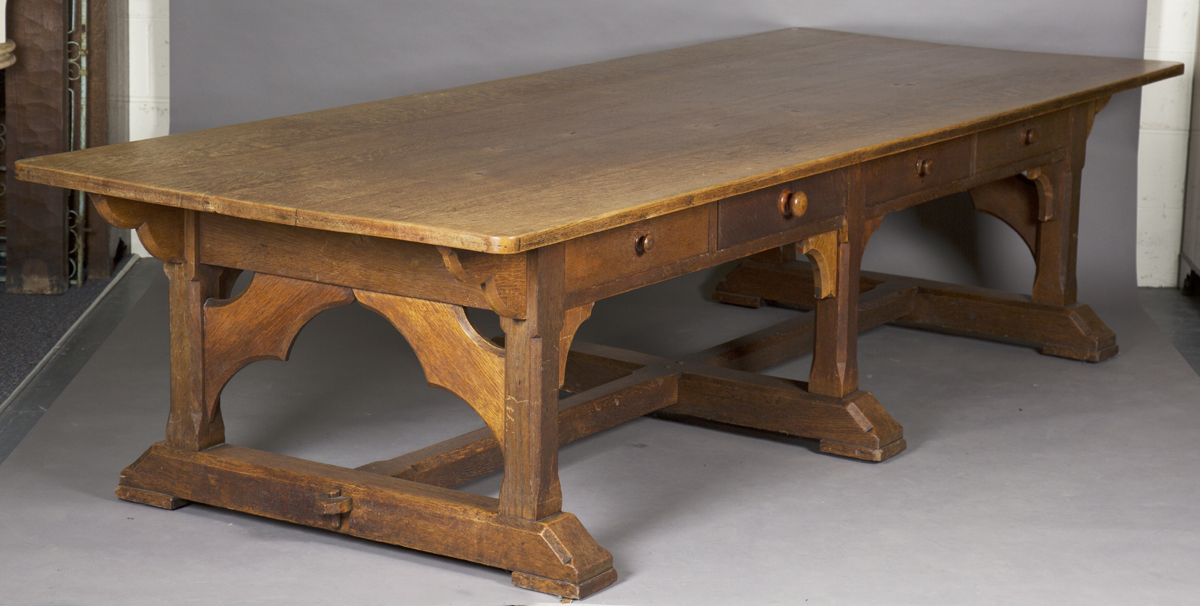 A large early 20th century Arts and Crafts oak refectory table, the rectangular top above eight