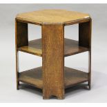 An early 20th century oak canted square book table, in the manner of Heals, height 61cm, width
