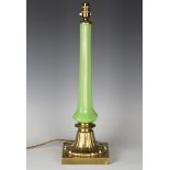 A late Victorian gilt bronze and green glass table lamp, the faceted octagonal stem raised on a