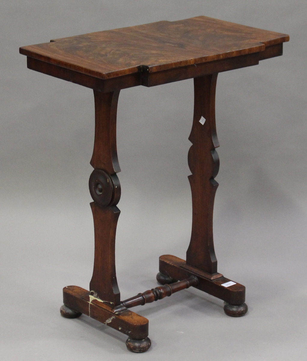 An early Victorian figured mahogany wine table, the shaped rectangular top on shaped twin