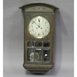 An early 20th century Arts and Crafts style oak wall clock with eight day chiming movement, height