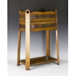 An early 20th century Arts and Crafts oak and copper mounted stick stand, in the manner of