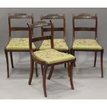 A set of four Regency stained beech and brass inlaid dining chairs with drop-in seats covering caned