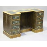 A 20th century Victorian style walnut inverted breakfront writing desk, fitted with eight oak-