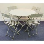 A 20th century green painted metal folding garden table, diameter 97cm, and a set of four folding