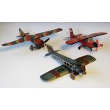 A Mettoy type tinplate clockwork high-wing monoplane with camouflage finish, wingspan 42cm, a