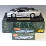 A Maisto 1/12th scale model of a Jaguar XJ220, finished in silver, and a Matchbox Masterclass