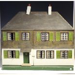 A Triangtois doll's house with faux tiled roof and two chimneys, the double-opening front