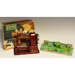 A Vulcan Senior child's sewing machine, boxed, a set of dominoes, a tinplate clockwork toy and a