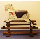 A Leeway dapple grey rocking horse with painted features, mane, tail and saddle, on a pine base,