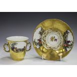 A Berlin two-handled chocolate cup and trembleuse saucer, 19th century, painted with opposing