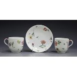 Two Continental porcelain teacups and a matching saucer, probably Doccia, late 18th century, painted