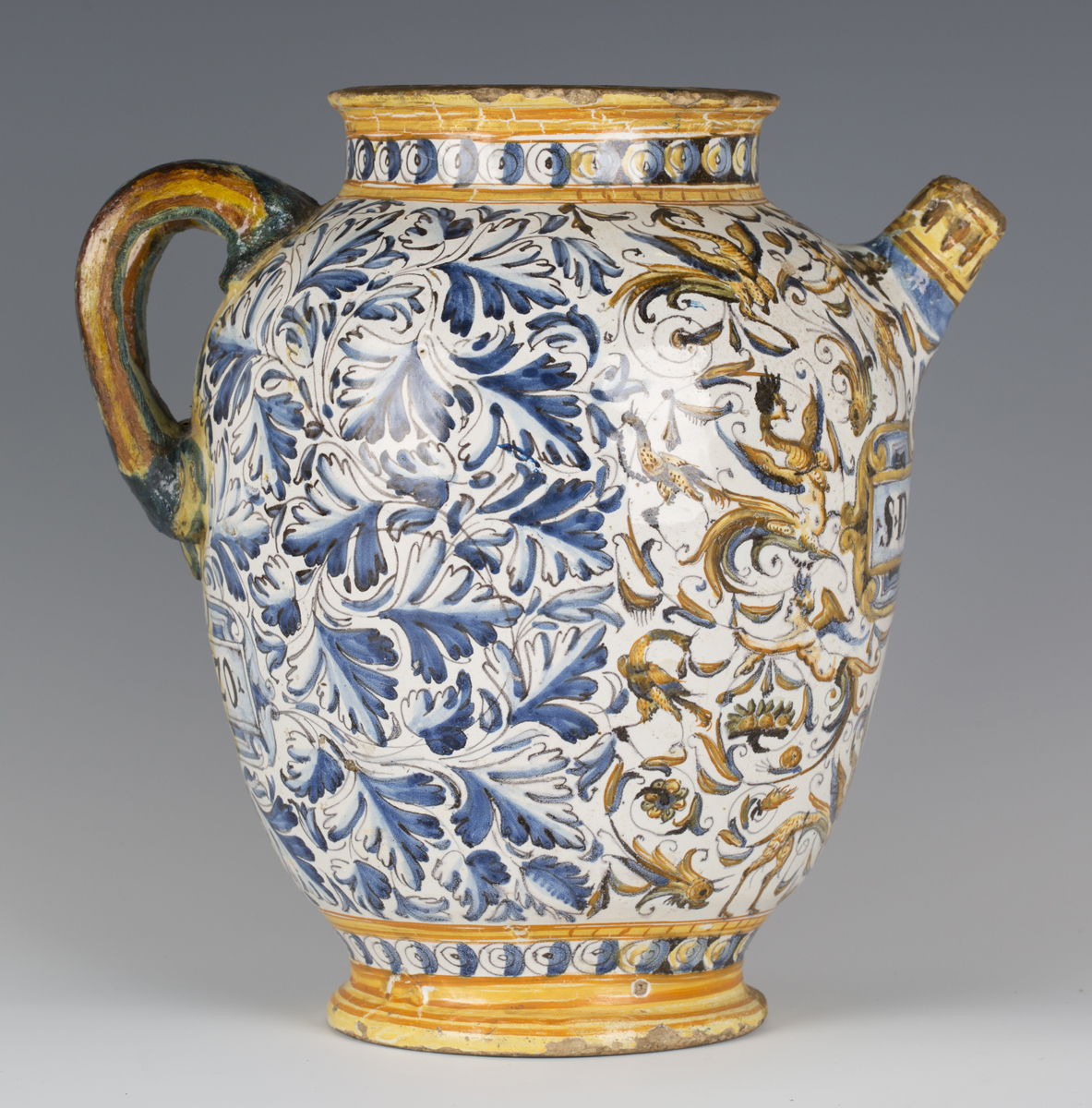 An Italian maiolica wet drug jar, probably Deruta, 17th century, the ovoid body painted to the front