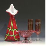 A small group of cranberry glassware, late 19th/early 20th century, including a pair of champagne