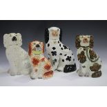 Four Staffordshire pottery spaniels, late 19th century, comprising a copper lustre example, one