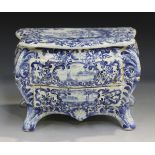 A Dutch Delft miniature model of a commode, 19th century, of bombé form with two workable drawers,