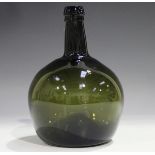 An olive green tinted glass wine bottle, late 18th/early 19th century, the bulbous body with kick in