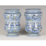 A pair of Italian maiolica small berettino albarelli or pill jars, Faenza, mid-18th century, both of