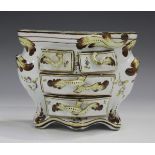 A French faience miniature model of a commode, 19th century, of bombé form with four workable