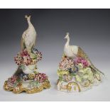 Two Royal Crown Derby peacocks, circa 1913 and 1918, one surmounted on an urn, the other on a tree